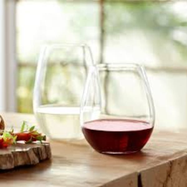 Two stemless wine glasses, one with red wine and one with white wine, on a wooden surface.