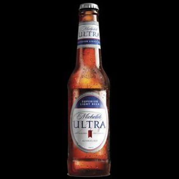 A Michelob Ultra beer bottle, condensation visible, against a black background.